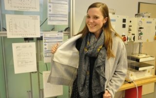 Project team member Susanne Aumann presents the stab protection cardigan in the laboratory at the Research Institute for Textiles and Clothing Phot...